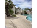 Community pool area showcasing a pool with desert landscaping and various seating areas at 9750 N Monterey Dr # 71, Fountain Hills, AZ 85268