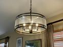 Close-up of a dining room light fixture with clear textured glass at 11807 E Clinton St, Scottsdale, AZ 85259