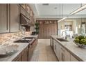 Gourmet kitchen featuring professional grade appliances, custom cabinetry, and stone countertops at 12311 E Black Rock Rd, Scottsdale, AZ 85255