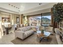 Bright living room features a modern sofa and a large sliding glass door with mountain views at 12311 E Black Rock Rd, Scottsdale, AZ 85255