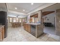 A spacious kitchen with tile floors, stainless steel appliances, and a kitchen island for food preparation at 1285 E Mcmurray Blvd, Casa Grande, AZ 85122