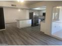 Bright, spacious kitchen with modern appliances, an island, and gray vinyl flooring at 1452 E Emerald Ave, Mesa, AZ 85204