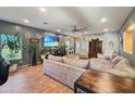 Open-concept living room featuring stylish decor, a large TV, and comfortable furnishings at 15203 N 153Rd Dr, Surprise, AZ 85379