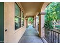 Covered walkway has neutral color scheme and decorative metal handrail at 15469 W Dreyfus St, Surprise, AZ 85379