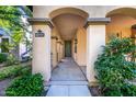 Inviting covered porch with decorative columns, slate floors, and green front door at 15469 W Dreyfus St, Surprise, AZ 85379