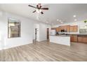 Bright and airy living space features neutral walls, wood floors and many doorways at 15469 W Dreyfus St, Surprise, AZ 85379