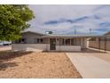 Charming single-story house boasts low-maintenance landscaping and a welcoming covered parking area at 1654 E 2Nd St, Mesa, AZ 85203