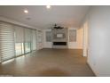 Open living room with tile flooring, modern fireplace, and lots of natural light at 18813 W Solano Dr, Litchfield Park, AZ 85340