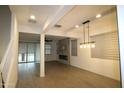 Bright living room boasts wood-look tile floors and a modern fireplace at 18813 W Solano Dr, Litchfield Park, AZ 85340