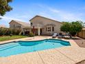 Private backyard features a refreshing swimming pool, lush greenery, and ample space for outdoor relaxation at 20404 N 28Th Pl, Phoenix, AZ 85050