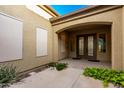 Inviting front entrance with double doors, desert plants and stone walkway at 21401 E Russet Rd, Queen Creek, AZ 85142