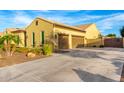 Spacious two-car garage with a wide driveway and desert landscaping at 21401 E Russet Rd, Queen Creek, AZ 85142