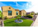 Beautifully landscaped side yard with green grass and desert foliage at 21401 E Russet Rd, Queen Creek, AZ 85142
