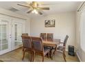 Formal dining room features a dark wood dining table with seating for six and french door access to yard at 2201 W Wethersfield Rd, Phoenix, AZ 85029