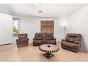 Inviting living room with tile flooring, comfortable seating arrangements, and ample natural light through a window at 2641 E Binner Dr, Chandler, AZ 85225