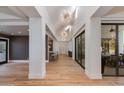 A long hallway boasts hardwood floors, recessed lighting, and modern architectural design at 2737 E Arizona Biltmore Cir # 8, Phoenix, AZ 85016