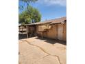 Home's exterior featuring covered patio with old swamp coolers, and a back entrance at 2825 E Adams St, Phoenix, AZ 85034