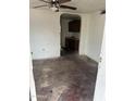 Interior of the living room showing an archway leading to the kitchen, ready for renovation at 2825 E Adams St, Phoenix, AZ 85034