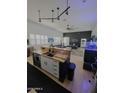 Kitchen with hardwood floors, bar, and black track lighting at 29606 N Tatum Blvd # 204, Cave Creek, AZ 85331