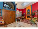 Bright living room showcasing colorful walls, a fireplace, stylish furniture, and unique decor at 3416 E Squawbush Pl, Phoenix, AZ 85044