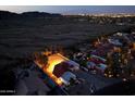 Aerial view showcases a community with a beautiful home and a serene desert backdrop at night at 3738 E Kachina Dr, Phoenix, AZ 85044