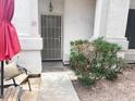 Front entryway with security door and shade umbrella near landscaped rocks at 4805 E Kachina Trl # 25, Phoenix, AZ 85044