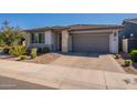 Beautiful single-story home with a gray garage door and a well-maintained front yard at 4925 S Turbine --, Mesa, AZ 85212