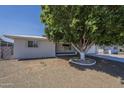 Charming single-story home features a well-maintained front yard with mature trees and a two-car garage at 5657 E Dallas St, Mesa, AZ 85205