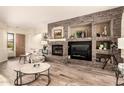 Spacious living room featuring a stone fireplace, built-in shelving, and hardwood flooring at 5749 S Dragoon Dr, Chandler, AZ 85249