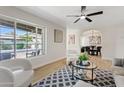 Spacious living room featuring stylish decor, a ceiling fan, and an open archway to the dining area at 6001 N 10Th Way, Phoenix, AZ 85014
