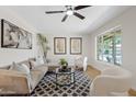 Bright living room with modern furnishings, a ceiling fan, and plenty of natural light at 6001 N 10Th Way, Phoenix, AZ 85014