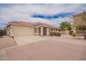 Charming single story home features a two car garage, desert landscaping, and a red tiled roof at 6085 S Wilson Dr, Chandler, AZ 85249