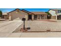 Inviting single-story home featuring a well-kept gravel front yard and a classic mailbox at 6602 W Ironwood Dr, Glendale, AZ 85302