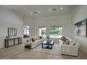 Bright living room featuring modern furnishings, high ceilings, and scenic views of the backyard pool at 7214 E Rustling Pass, Scottsdale, AZ 85255