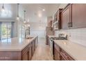 Well-lit kitchen with a large island, stainless steel appliances, and modern fixtures at 809 W Coles Rd, Phoenix, AZ 85041