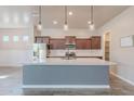 Bright kitchen features stainless steel appliances, sleek white countertops, and dark wood cabinets at 809 W Coles Rd, Phoenix, AZ 85041