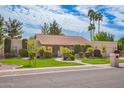 Charming single-story home with a well-manicured lawn, mature trees, and an attached two-car garage at 8851 S Juniper St, Tempe, AZ 85284