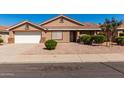 Charming single-story home featuring a well-manicured, low maintenance landscaped front yard and two-car garage at 1147 N Marvin St, Gilbert, AZ 85233