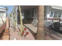 Charming mobile home with desert landscaping, a golf cart, and a cozy covered patio at 1311 W Chesapeake Dr, Apache Junction, AZ 85119