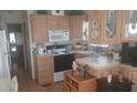 Charming kitchen with classic wood cabinets, white appliances, and ample countertop space at 1311 W Chesapeake Dr, Apache Junction, AZ 85119