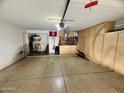 Spacious two-car garage with built-in storage and a workbench at 135 S Abalone Dr, Gilbert, AZ 85233