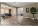 Spacious room with tiled flooring and views into the dining and sitting areas with an open concept design at 15422 W Ventura St, Surprise, AZ 85379