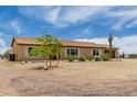 Quaint one-story home with attached two car garage; neutral color scheme blends in with desert landscaping at 16415 W Oyer Ln, Surprise, AZ 85387