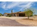 Quaint one-story home with attached two car garage; neutral color scheme blends in with desert landscaping at 16415 W Oyer Ln, Surprise, AZ 85387