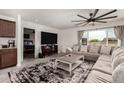 Comfortable living room featuring a plush sectional sofa, decorative rug, and access to a bedroom at 16415 W Oyer Ln, Surprise, AZ 85387
