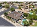 Aerial view of property showcasing a swimming pool, patio, and the surrounding neighborhood at 1656 W Meseto Cir, Mesa, AZ 85202