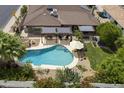 Aerial view of backyard showing pool, patio area and beautiful landscaping at 1656 W Meseto Cir, Mesa, AZ 85202