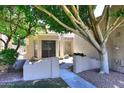 Inviting walkway leading to a charming home with mature shade tree and decorative front door at 1861 E Bendix Dr, Tempe, AZ 85283