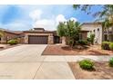 Beautiful exterior of a home featuring desert landscaping, stone accents, and a spacious driveway at 18719 E Pelican Ct, Queen Creek, AZ 85142