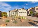 Lovely single-story home boasting a two-car garage and attractive desert landscaping at 19667 N 260Th N Ln, Buckeye, AZ 85396